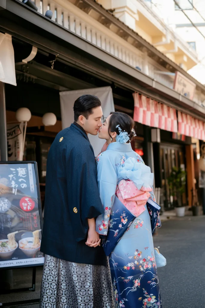 Couple in premium furisode and men's montsuki hakama kissing on Nakamise-dori, Asakusa Tokyo