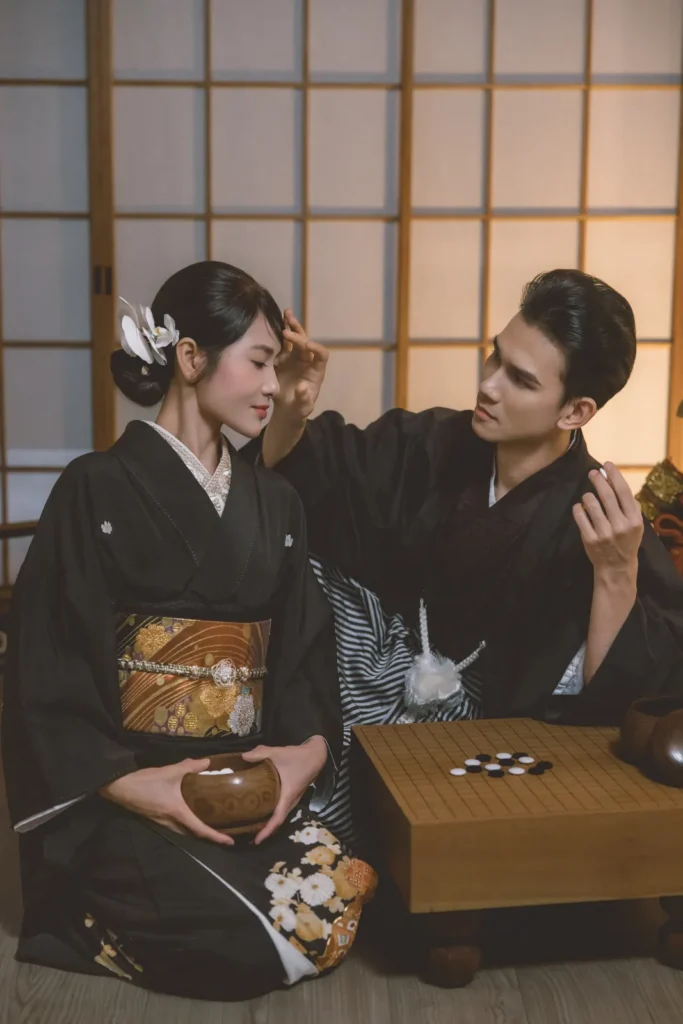Couple in black kimono playing go during a studio kimono photoshoot at Kimono Rental Ann in Asakusa, Tokyo