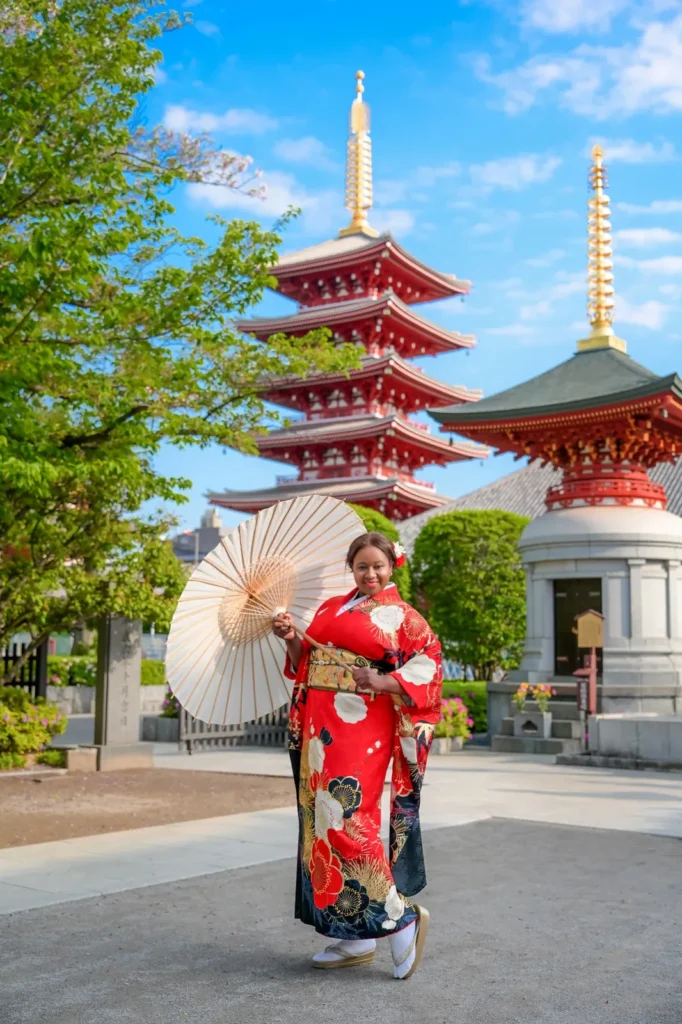 Red plum blossom plus size kimono with a white paper parasol in the Sensoji temple grounds