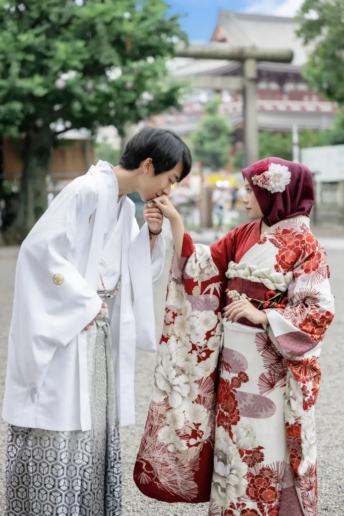 Maroon hijab with a white flower ornament worn with a red and white floral furisode at Sensoji Temple
