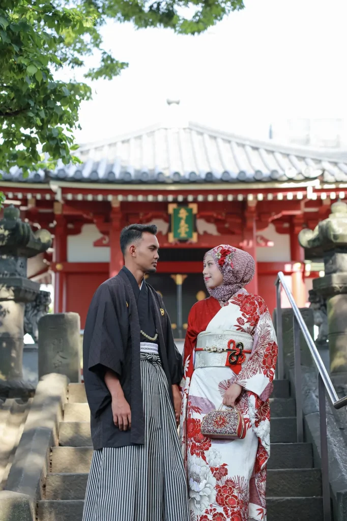 Red and white patterned hijab matched with a red and white floral kimono, couple at a temple gate in Asakusa